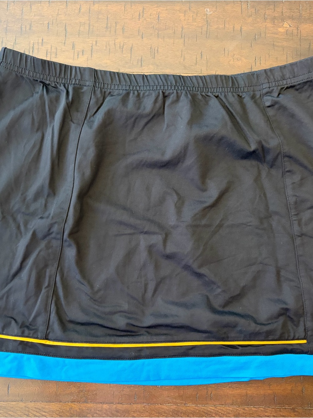 Tail Black Athletic Skirt with Blue Hem and Yellow Accent